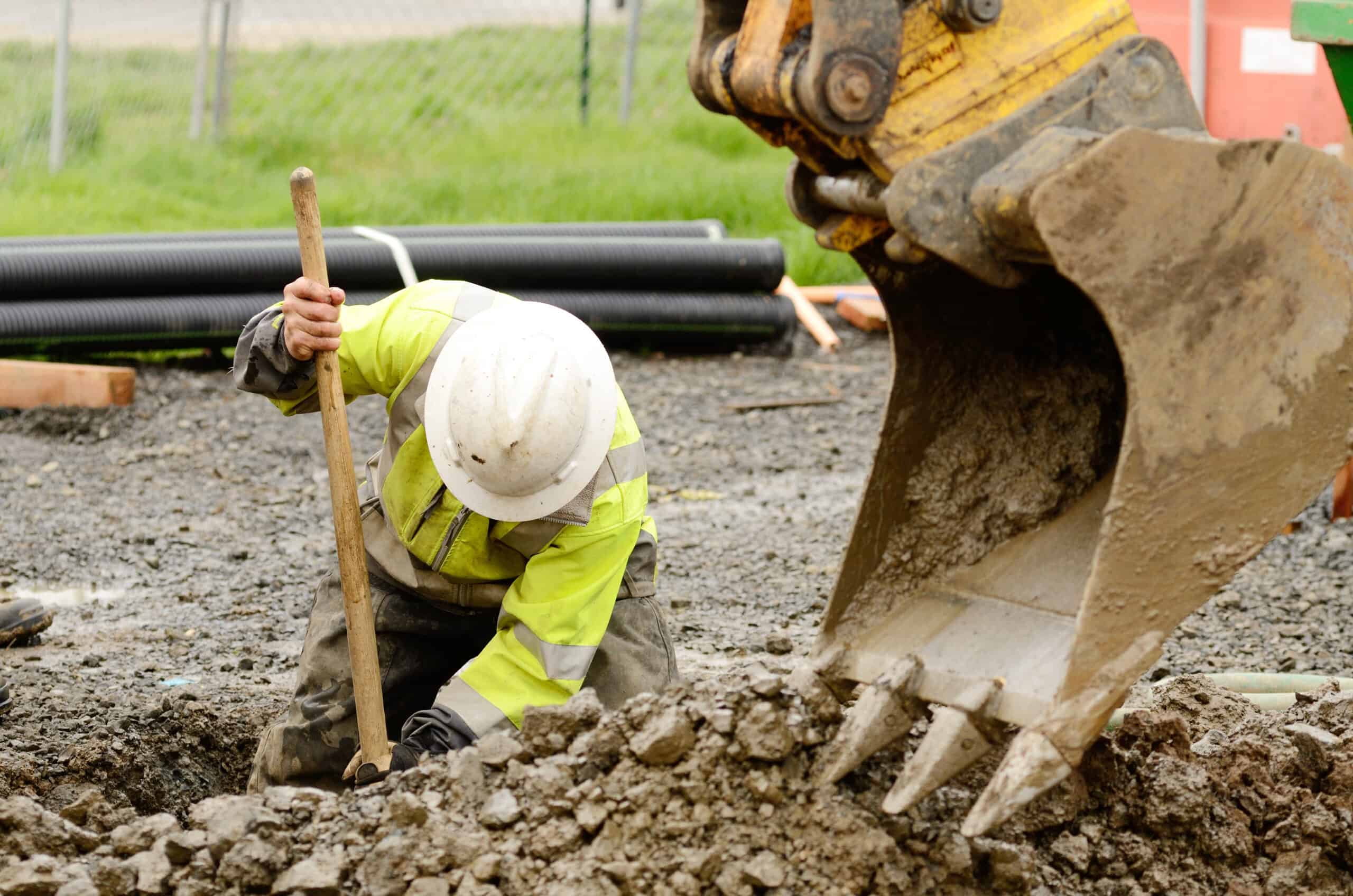 Lead service line Worker using an excavator to dig a hole to replace a lead water main