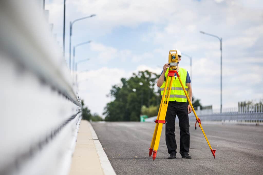 Engineer surveying a city highway