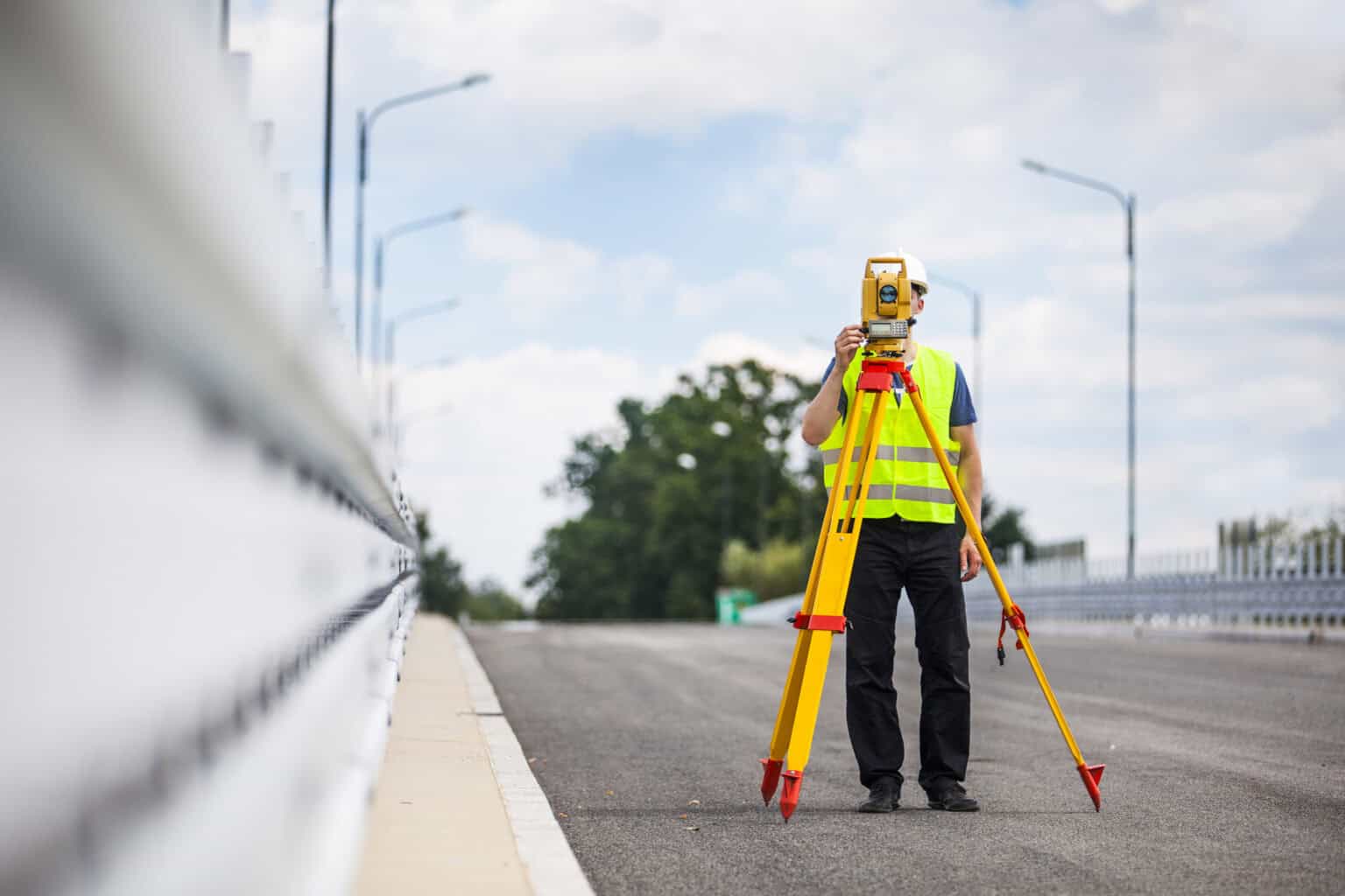 Engineer surveying a city highway